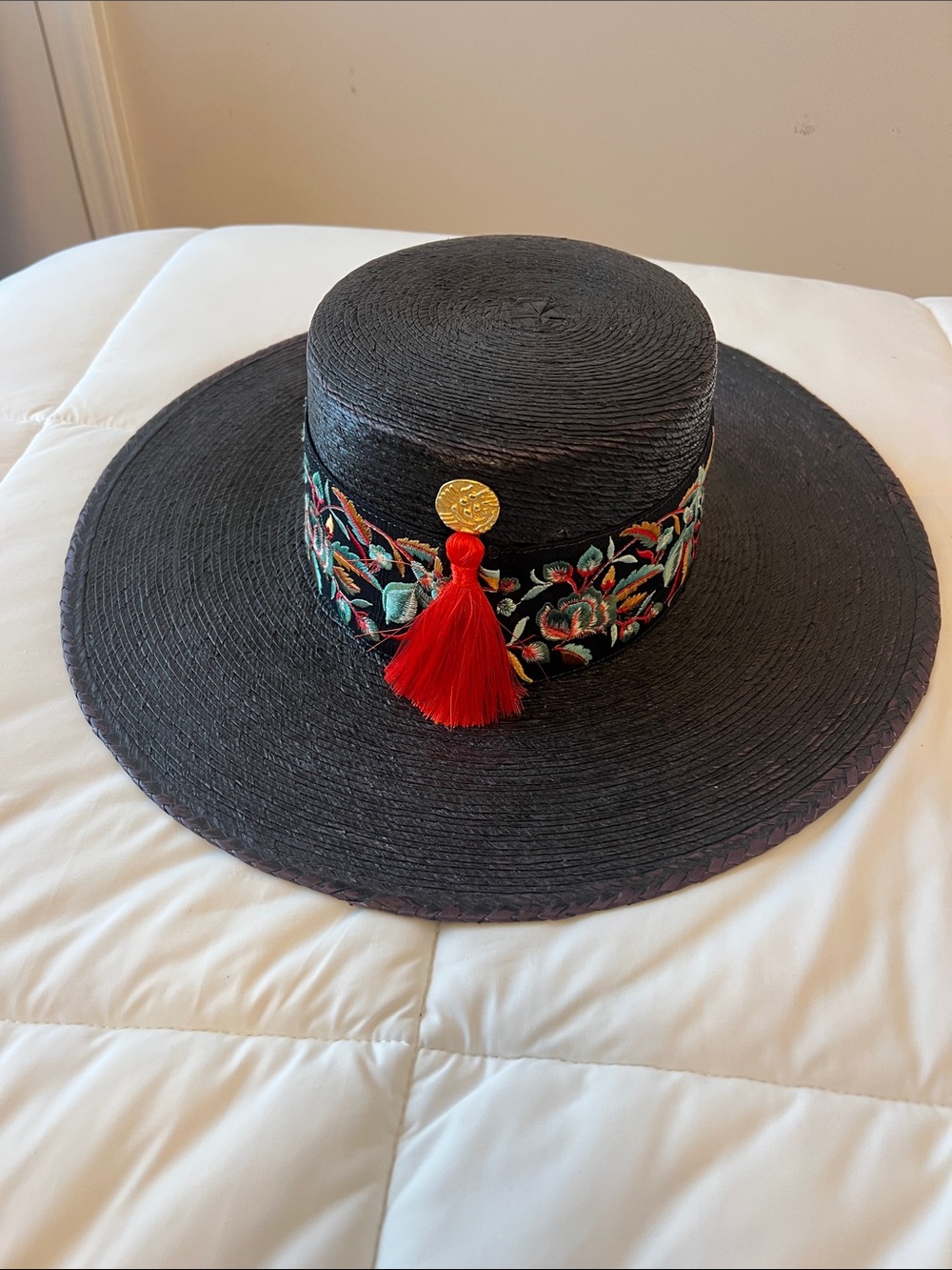 Black Wide-Brim Straw Hat with Embroidered Band and Red Tassel Accent